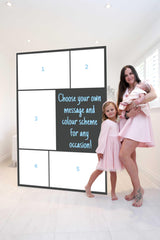Mother, baby and child posing in front of Custom Collage Mega Card