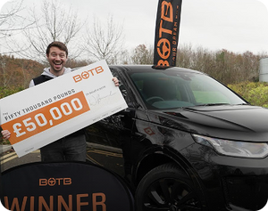Competition winner holding a large £50,000 novelty cheque next to a new black car.
