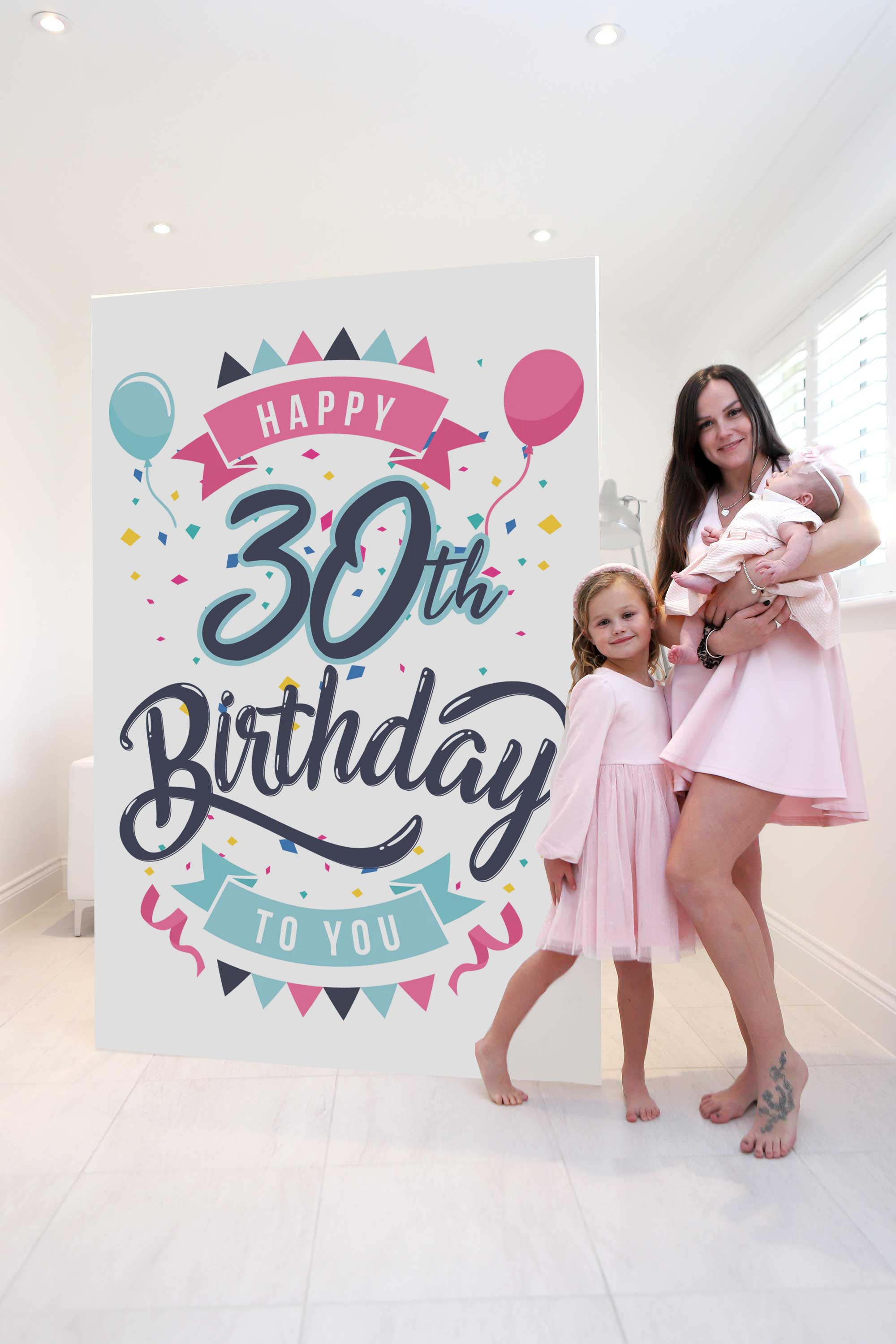 Mother, daughter and baby posing with giant Custom Birthday Mega Card