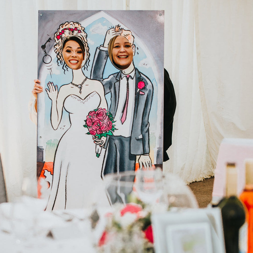 Ball and Chain face in the hole board in use by two guests at a wedding reception